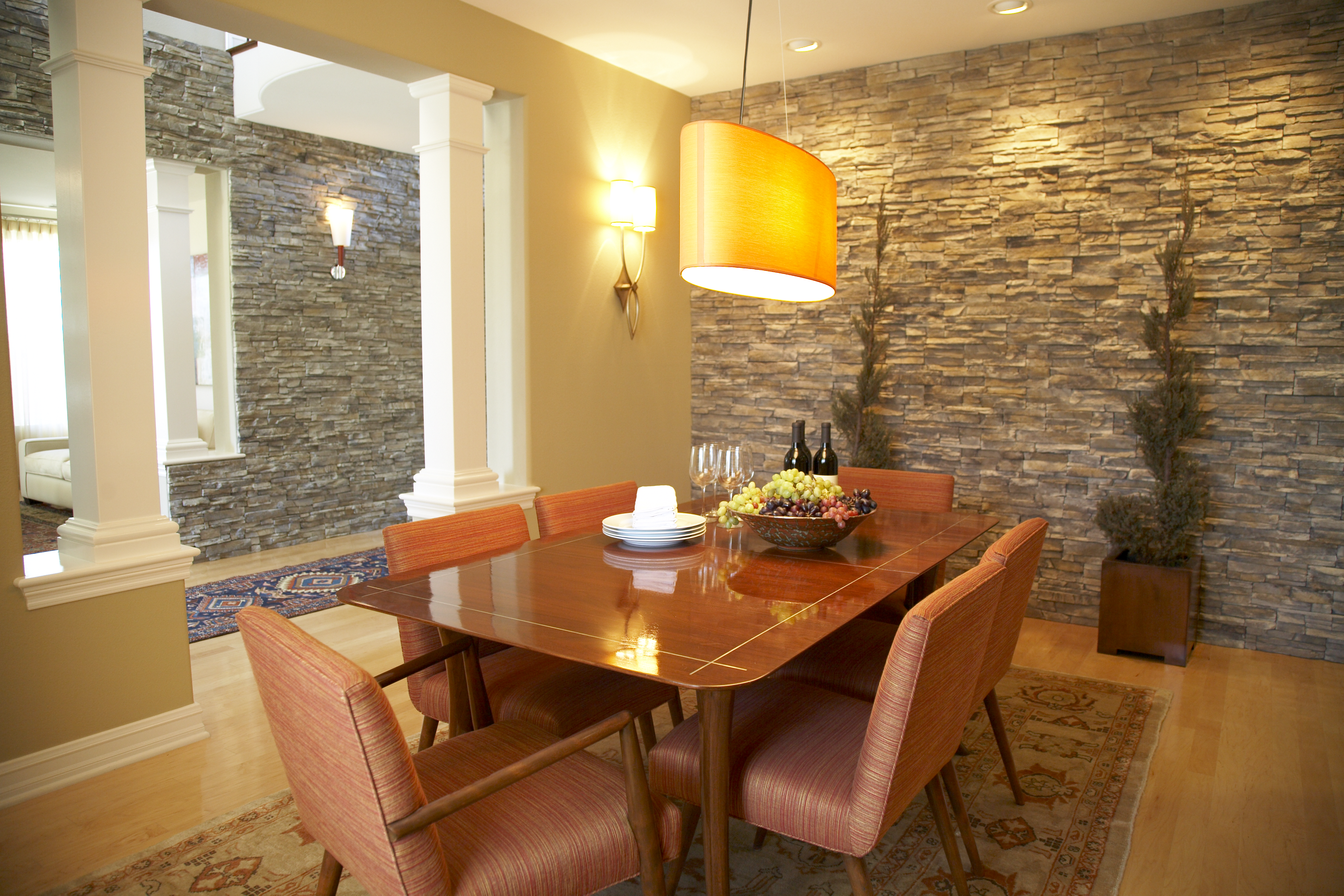 Contemporary dining room with stone wall detail